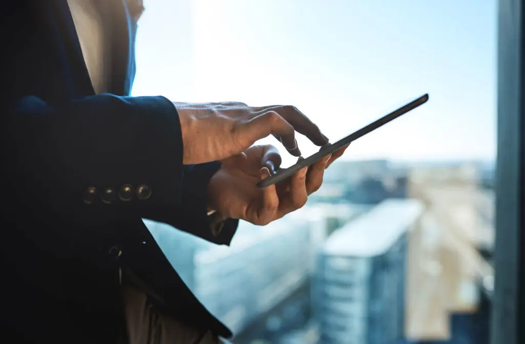 Property manager scrolling on a tablet in a high-rise building